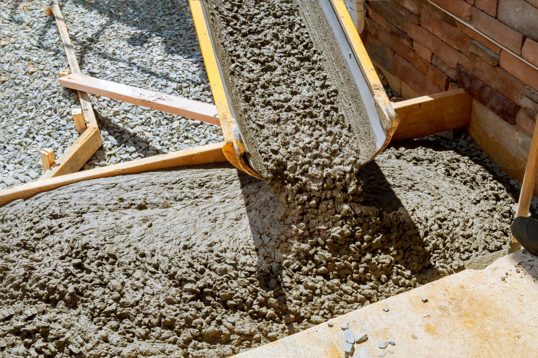 Pouring cement during paving concrete pavement near the driveway